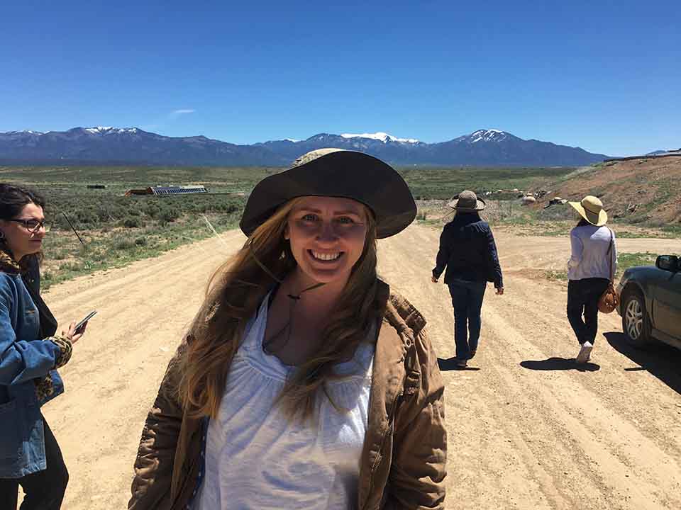A student enjoying the view of the Sangre De Cristo Mountains while attending a graduate creative writing class at the Doel Reed Center.