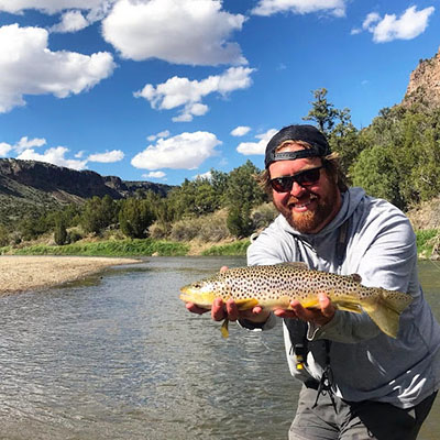 Fly fishing instructor Nick Streit holding a fish