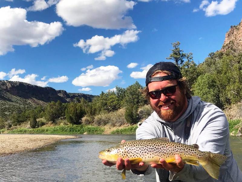 Flyfisherman poses with trout