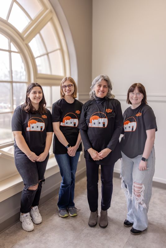 Carol Moder and students modeling winning tshirts