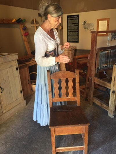 Woman standing next to chair
